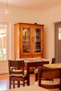 a dining room with a table and a wooden cabinet at Casa do Lado in Vila Nova de Milfontes