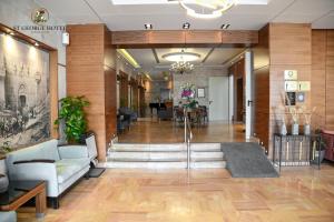 a lobby of a hospital with chairs and tables at St. George Hotel in Jerusalem