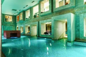 a lobby of a building with a swimming pool at Rimske Terme Resort - Hotel Sofijin dvor in Rimske Toplice