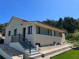 a house with a staircase in front of it at Fornas House in Caminha