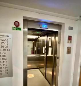 an elevator in a building with a sign on it at A Home in the City. in Sheffield