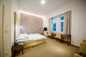Postel nebo postele na pokoji v ubytování Rimske Terme Resort - Hotel Sofijin dvor