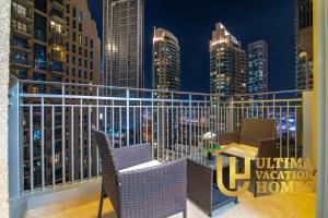 a balcony with a view of a city at night at Stylish 1BR-Next to Dubai Mall in Standpoint B in Dubai