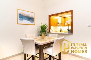a dining room with a table and chairs and a mirror at Stylish 1BR-Next to Dubai Mall in Standpoint B in Dubai