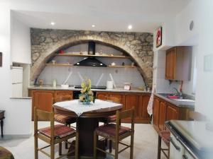 a kitchen with a table and a stone wall at Casa Relax in Carunchio