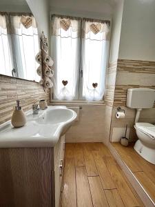a bathroom with a sink and a toilet at Cà del Vins - Studio Flat in La Spezia in La Spezia +17 photos