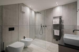 a bathroom with a shower and a toilet and a sink at Villa Rames in Ortisei