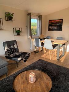 a living room with a table and chairs at Chalet Rivendell in Menaldum