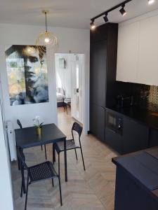 a kitchen and dining room with a table and chairs at Apartament Nowy Władek 1 in Władysławowo