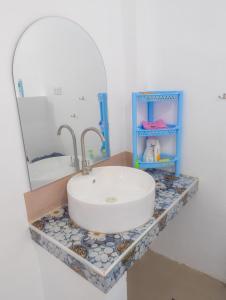 a bathroom with a sink and a mirror at Truth be Found Ministry Resort in Jagna
