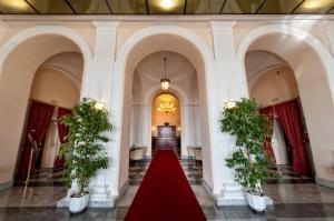 a hallway with a red carpet in a building at Hotel San Giorgio in Civitavecchia