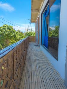 a wooden balcony with a view of the ocean at Truth be Found Ministry Resort in Jagna