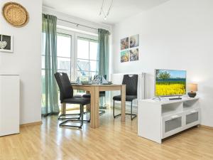 a dining room with a table and two chairs at Haus Sonnenschein Sonnenwinkel in Insel Poel