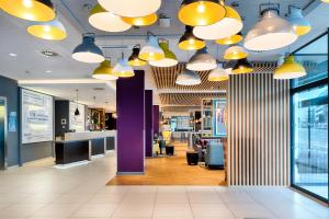 a lobby with yellow lights on the ceiling at Premier Inn Leipzig City Hahnekamm in Leipzig