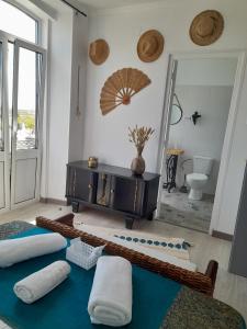a room with pillows on the floor and a bathroom at Casa Chanel in Figueira da Foz