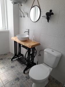 a bathroom with a white toilet and a sink at Casa Chanel in Figueira da Foz +53 photos