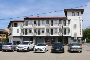 a group of cars parked in a parking lot in front of a building at SPA Guest House Valentina in Yagoda