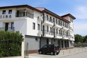 a van parked in front of a building at SPA Guest House Valentina in Yagoda