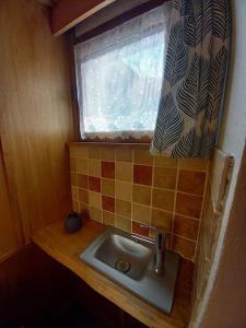 a small bathroom with a sink and a window at Comps sur Artuby, le tilleul et le four, Jabron in Comps-sur-Artuby