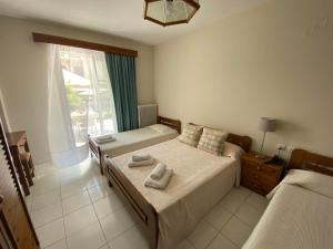 Postel nebo postele na pokoji v ubytování Hotel Pavlos - Studios