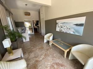 a living room with a couch and a table at Hotel Pavlos - Studios in Tolo