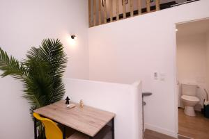 a dining room with a wooden table and a toilet at Le Nostradamus - Magnifique appartement cours principal plein centre avec parking in Salon-de-Provence +43 photos