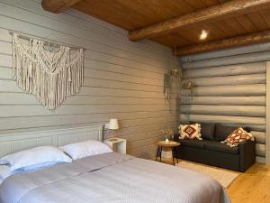 um quarto com uma cama e um sofá num quarto em Апартаменти БАРВА em Beloberëzka
