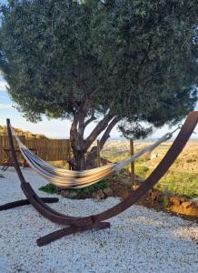 a hammock in front of a tree at Glamping Finca el Olivo in Mijas