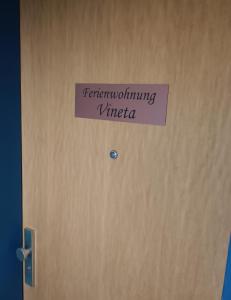 a sign on a door with the words transforming virinia at FeWo Vineta in Barth