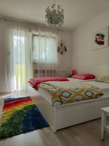 a bedroom with a bed with a colorful blanket at Danube in Vukovar