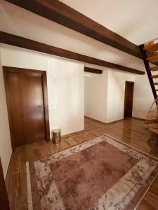 an empty room with a door and a rug at Cozy Weekend House Zaid in Bihać