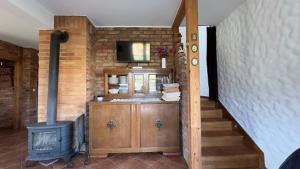 a living room with a stove and a staircase at Dom w sercu Kaszub in Parchowo +16 photos