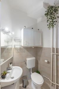a white bathroom with a toilet and a sink at Best Location, Family friendly Panorama view by NW in Budapest