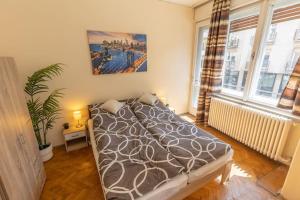 a bedroom with a bed and a large window at Best Location, Family friendly Panorama view by NW in Budapest