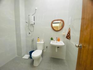 La salle de bains est pourvue de toilettes et d'un lavabo. dans l'établissement Warm Smile Homestay, 