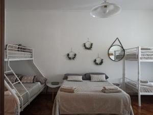 a bedroom with two bunk beds and a mirror at Villa Flora Affittacamere in Luni +70 photos