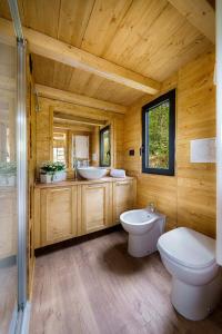 a wooden bathroom with two sinks and a toilet at Agriturismo Biologico Autosufficienza in Bagno di Romagna