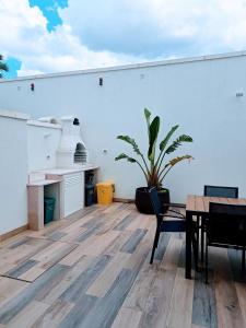 a room with a table and a potted plant at Pescoluse Apartments in Marina di Pescoluse +92 photos