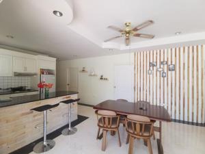 a kitchen with a table and chairs and a ceiling fan at Pool Villa 92 in Ban Nong Pru