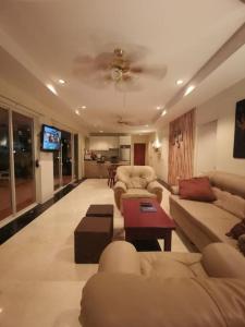 a living room with couches and a ceiling fan at Pool Villa 92 in Ban Nong Pru