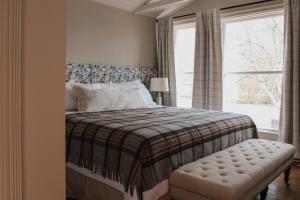 a bedroom with a bed and a window at The Cooper's Inn in Shelburne