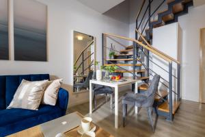 a living room with a blue couch and a table at Deluxe Apartments by The Railway Station Wroclaw in Wrocław