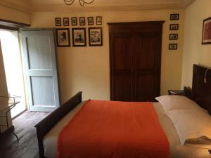 a bedroom with a bed with a red blanket at Entroterra Langa in Borgomale