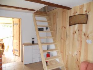 a wooden ladder in a room with a wall at Koča na planini Jelje - Pokljuka in Goreljek