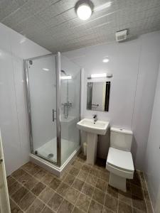 a bathroom with a shower and a toilet and a sink at Green Gables Hotel in Scarborough