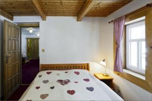 a bedroom with a bed with hearts on it at Penzion Marienka in Pec pod Sněžkou