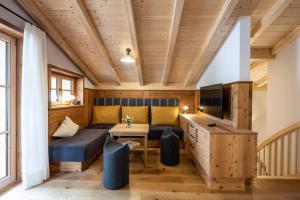 a living room with a couch and a table at Waldchalets & Ferienwohnungen Allgäu in Burgberg