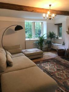 a living room with a couch and a rug at Charming Grade 2 listed building in Wiltshire in Melksham