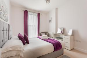 a bedroom with a large bed and a window at Queens Lodge, Redhill in Redhill