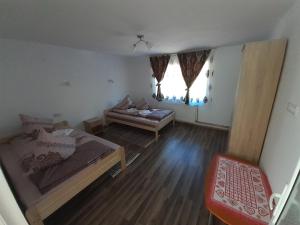 a small room with a bed and a couch in it at Cabana Colț de Rai in Arieşeni